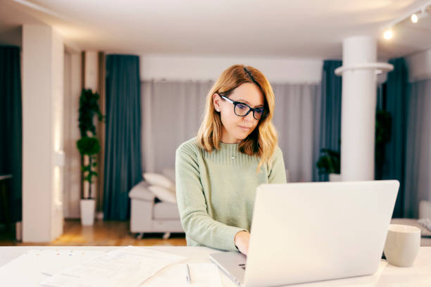 istock A middle-aged woman working from home on laptop. 1366417542
