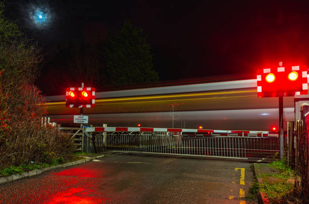 railroad crossing during a winter afternoon in a city in england, january 2022. - railroad crossing railway signal gate nobody imagens e fotografias de stock