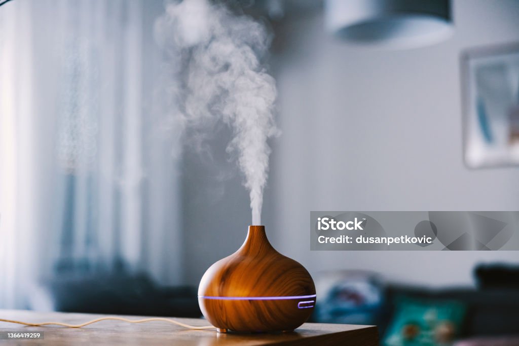 Humidifier with steam moisturizing air at home. Aromatherapy Diffuser Stock Photo