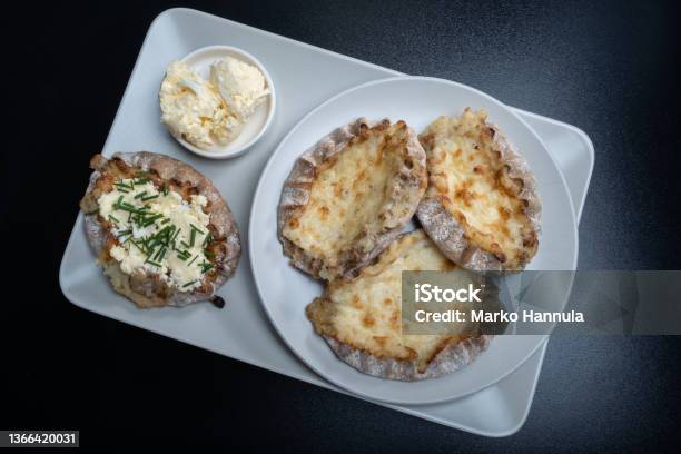 Traditional Finnish Foods Fresh Karelian Pies With Rice Pudding Filling And Egg Butter And Chives Topping Against Black Background Stock Photo - Download Image Now