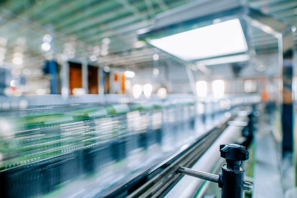 motion blurred fast moving water bottles at Mineral water Factory production line at finishing line in a row moving queuing for labelling packing motion blurred fast moving water bottles at Mineral water Factory production line at finishing line in a row moving queuing for labelling packing rushes plant stock pictures, royalty-free photos & images