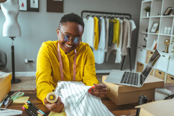 istock Female graphic designer examining clothes in design studio 1366424880