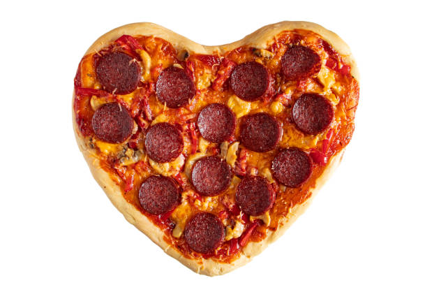 istock Heart shaped pepperoni pizza isolated on white background. Valentines day gift. Festive dinner. 1366424943