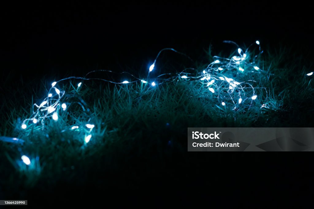 This stack of led tumblr lights Stacked blue lights are intentionally placed on the grass Abstract Stock Photo