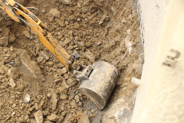 istock Excavator shovel digs into gravel ground 1366426265