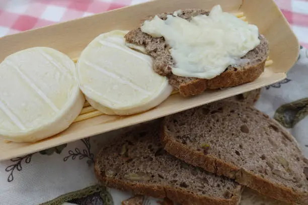 Rocamadour goat cheese served with slices of walnut bread