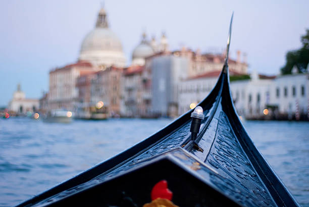Gondola at twilight in Venice on GrandCanal. Inside view stock photo