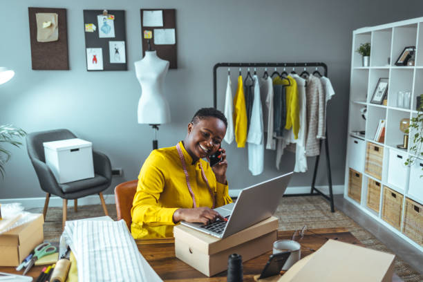 istock Small business owner using laptop and smartphone. 1366428340
