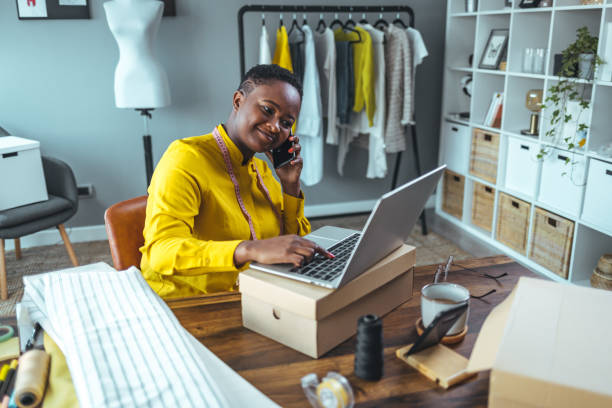 istock Small business owner using laptop and smartphone. 1366430398