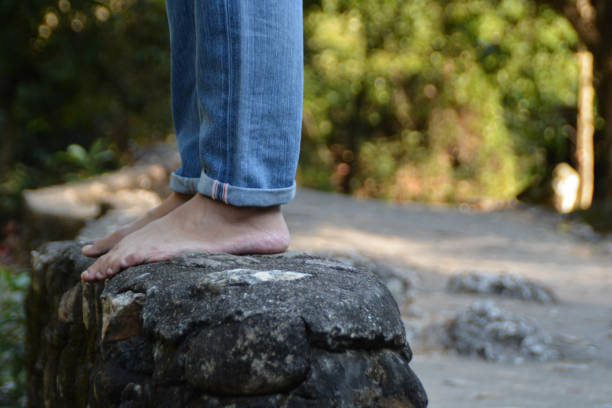 istock Someone wearing jean stand on the rock at the waterfall. 1366432230