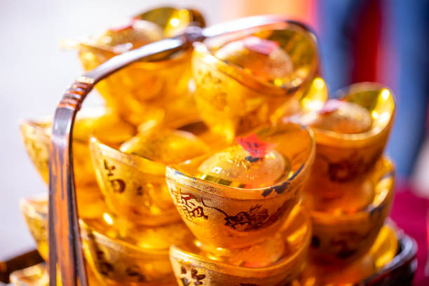 Gold ingots in bamboo baskets, traditional Chinese New Year ornaments (text: Wealth and treasure)