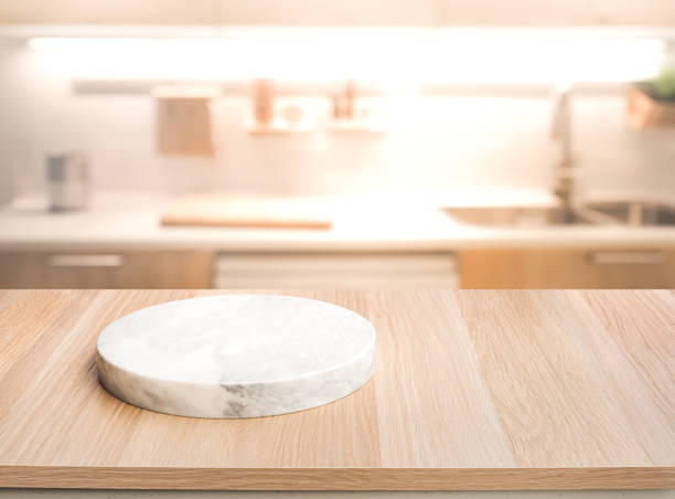 istock Selective focus.Wood table top with chopping board with blur kitchen counter background. 1366432555