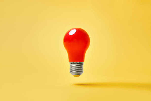 istock Red lightbulb levitate on yellow background. Idea, motivation concept 1366433564