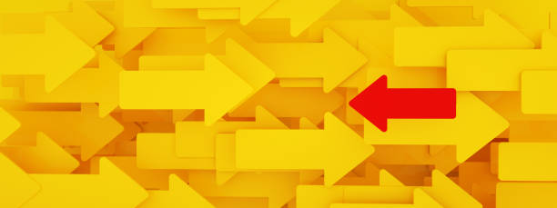 istock yellow arrows background with one red arrow 1366433578