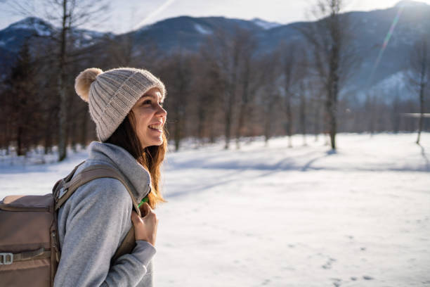 istock Young woman hikes through snowy landscape 1366435936