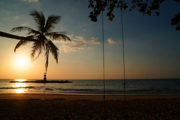 istock Landscape nature sunset and red  twilight sky with Silhouette  lighthouse coconut tree at Nang Thong Beach at Khao Lak Phang Nga Thailand - Seascape chill vibe on the beach - beautiful sky 1366438787