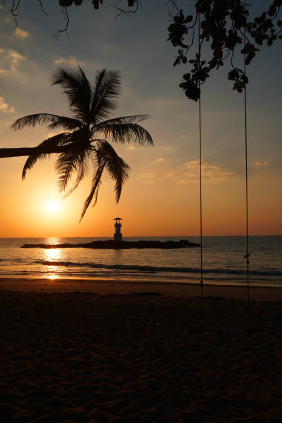 istock Landscape nature sunset and red  twilight sky with Silhouette  lighthouse coconut tree at Nang Thong Beach at Khao Lak Phang Nga Thailand - Seascape chill vibe on the beach - beautiful sky 1366438880