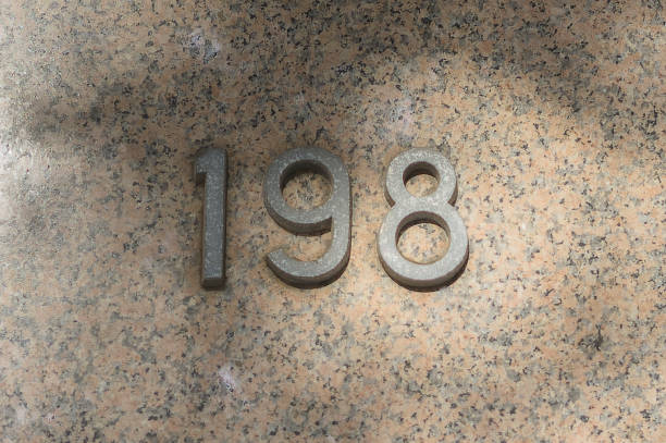 istock House number one hundred and ninety-eight on a marble wall. 1366441912
