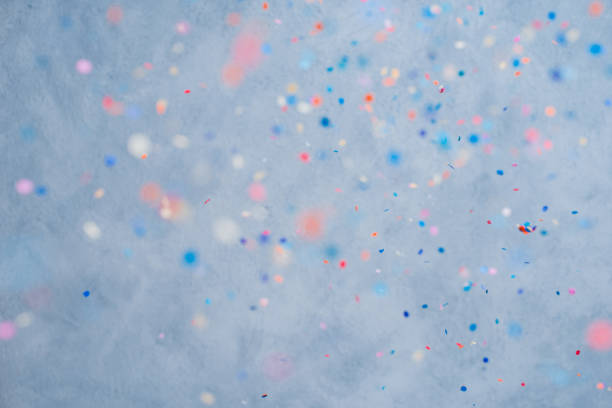 istock Colorful confetti falling on a holiday on a blue background 1366445758
