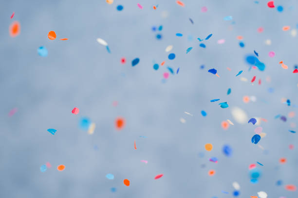 istock Colorful confetti falling on a holiday on a blue background 1366445808