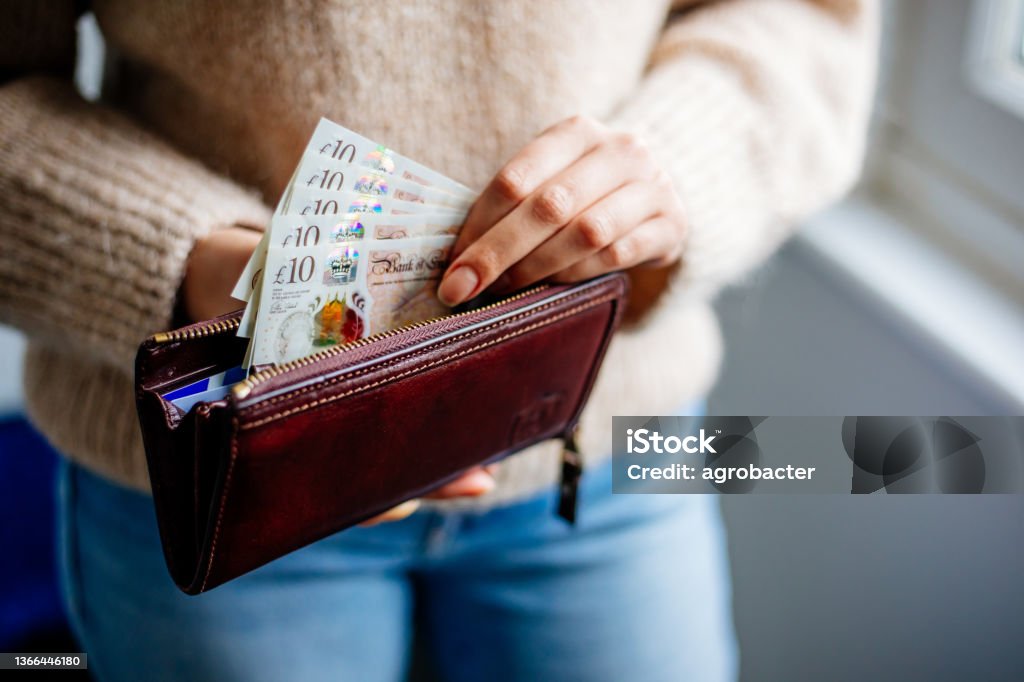 Woman Holding British Pound Currency Stock Photo