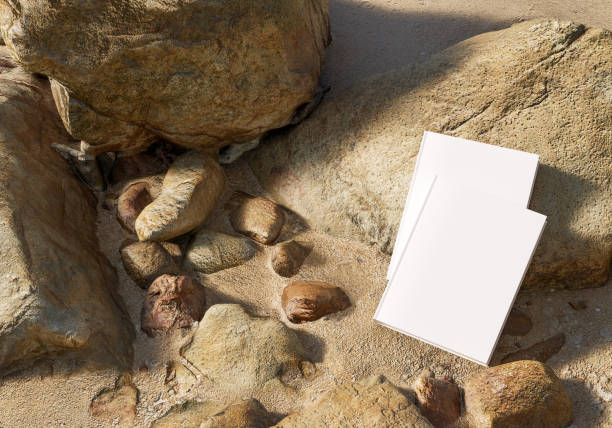 istock Blank book model placed on rocks in the sand, notebook mockup, mockup on nature background 04 1366446437