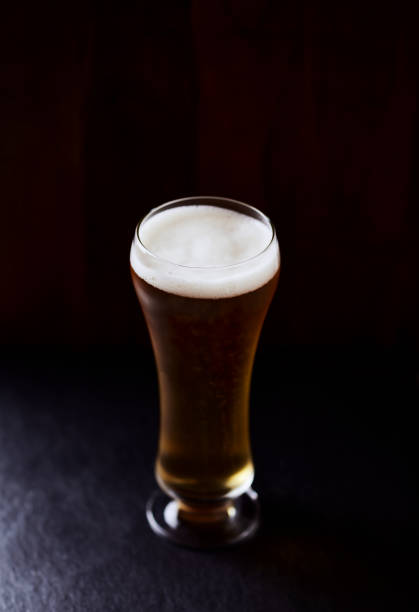 istock Glass of beer on stone background. Copy space. 1366446521
