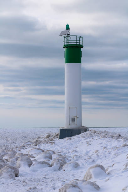 istock Grand Bend Lighthouse Overlooking the Frozen Lake (Portrait View) 1366446561
