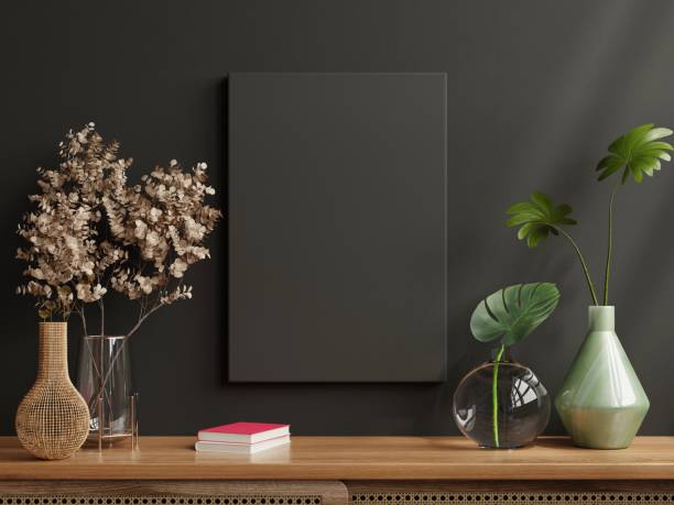 istock Mockup black frame on cabinet in living room interior on empty dark wall background. 1366447320
