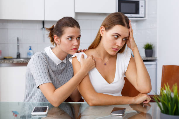 istock Girl calming her depressed friend 1366447387