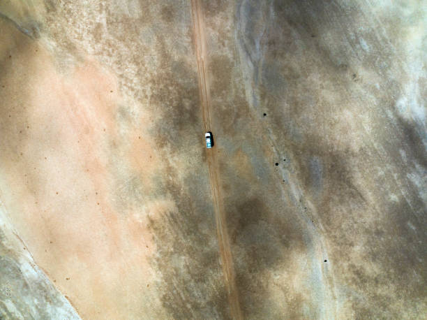 Off-road vehicle on dirt road from above