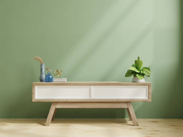 istock Modern wooden commode for tv mockup in empty room with green wall. 1366447608