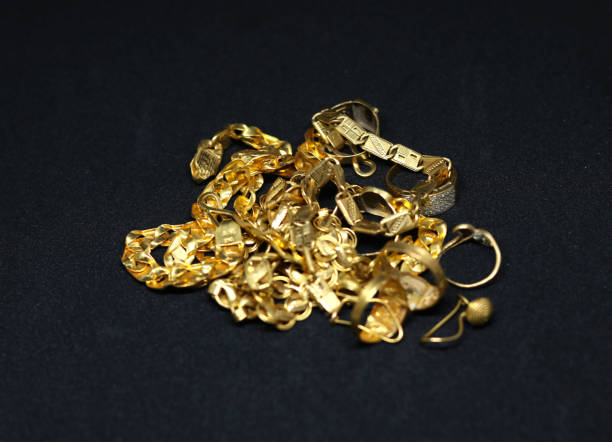 istock gold jewelry with gold chain ring earring with black background 1366447813