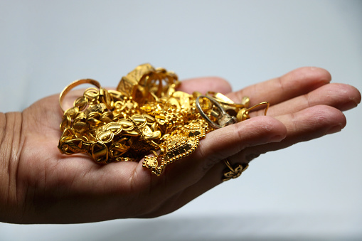 Women hand holding mix Gold jewelery (ornament)