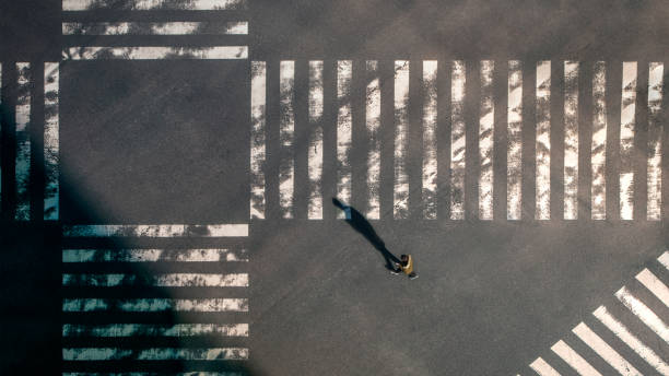 istock Elevated view over a man using smartphone on pedestrian crossing road at Japan 1366447931
