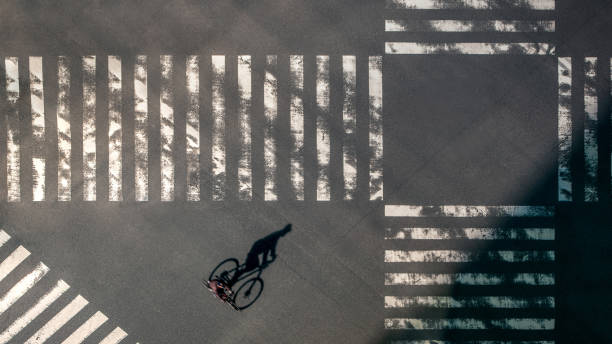 istock Elevated view over a biker man on pedestrian crossing in road intersection Japan 1366447948
