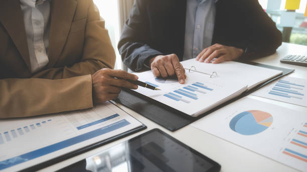 istock Business team brainstorming and discussing with financial data and report graph. Teamwork meeting working concept. 1366449067