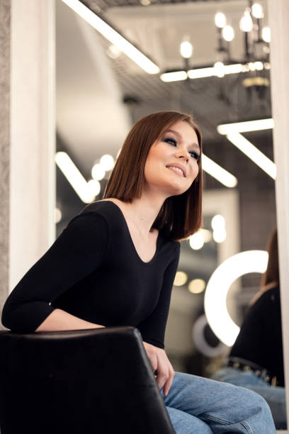 istock the model looks at her make-up and admires herself 1366449242