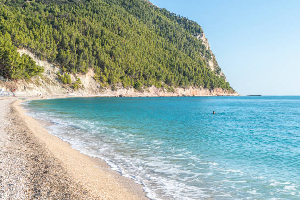 The beautiful beach of San Michele in Sirolo with blue water stock photo