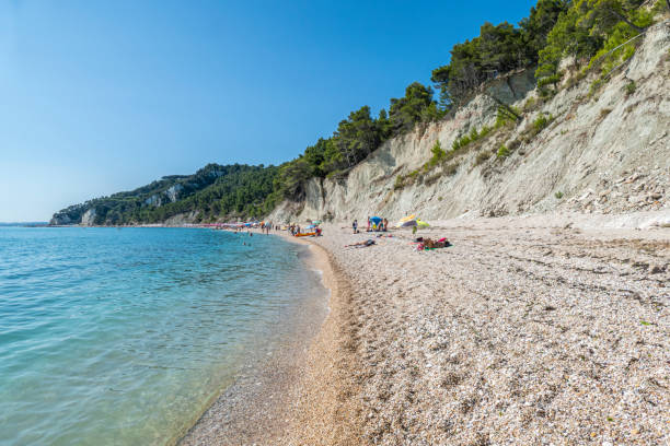 The beautiful beach of San Michele in Sirolo with blue water stock photo
