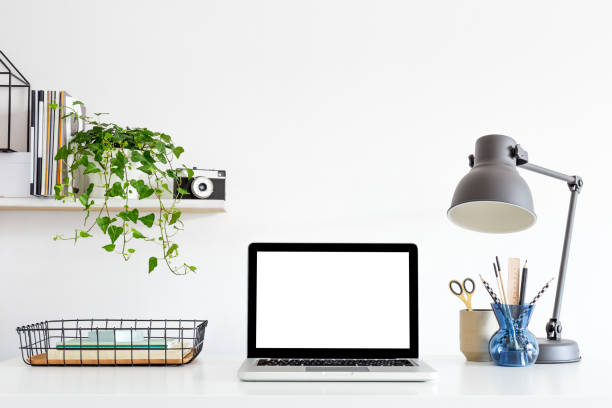 istock Aesthetic composition with laptop at home office desk with design lamp, camera and office supplies. Creative desk. 1366450230