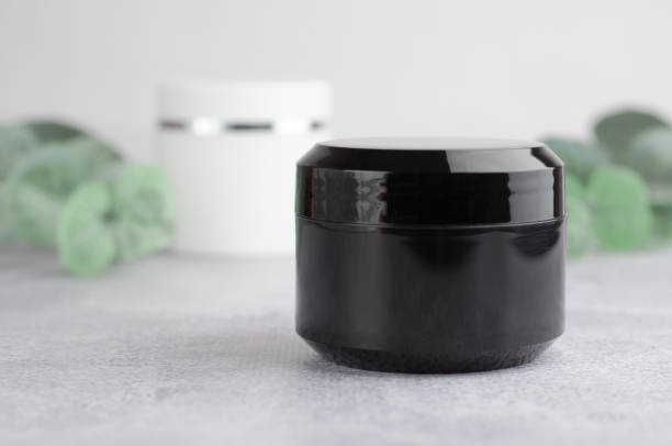 istock Moisturizing cream black packaging mockup. Closed black jar of moisturizer. The concept of natural cosmetic products 1366456748