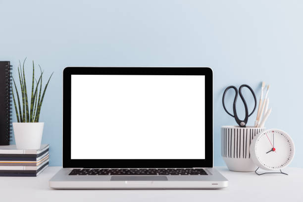 istock Mock up laptop, notebook on young student desk against blue wall. Back to school mock up. 1366457523