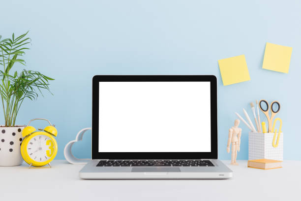 istock Mock up laptop, notebook on young student desk against blue wall. Back to school mock up. 1366457552