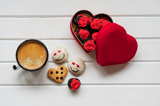 Top view of hot Coffee cup with a barista art heart shape foam on red heart paper background.  Festive card for Valentines Day. top view. flat lay. 3D illustration