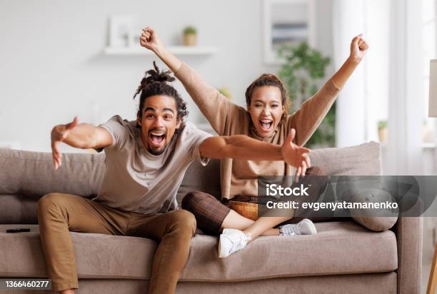 Overjoyed Young African American Couple Celebrating Goal While Watching Football Match Together Stock Photo - Download Image Now