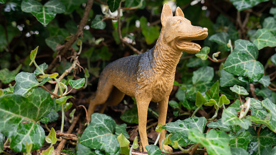 Dog figure, plastic toy in nature.