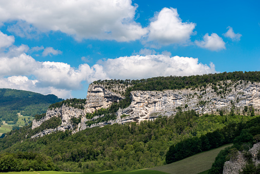 View over the mountain ranges and their grasslands and forests in the morning light in the northern Jura Mountains of the canton of Solothurn near the Passwang mountain pass