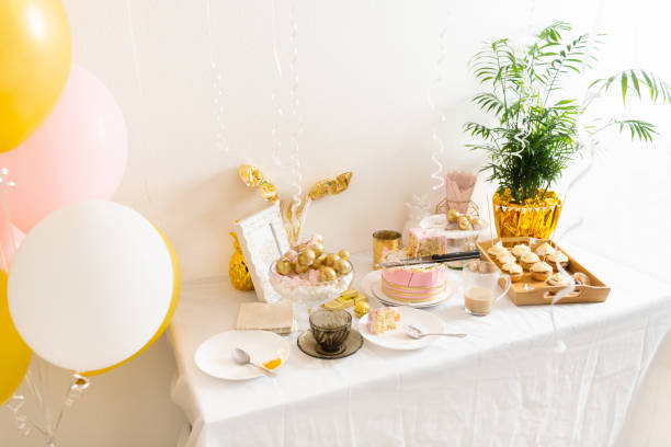 istock Table with leftovers after birthday with coffee, cake, cupcakes 1366466165