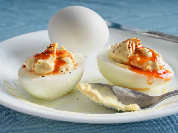 istock Eggs of the devil, spicy deviled eggs with red hot sauce on top a savory snack or appetizer 1366467810